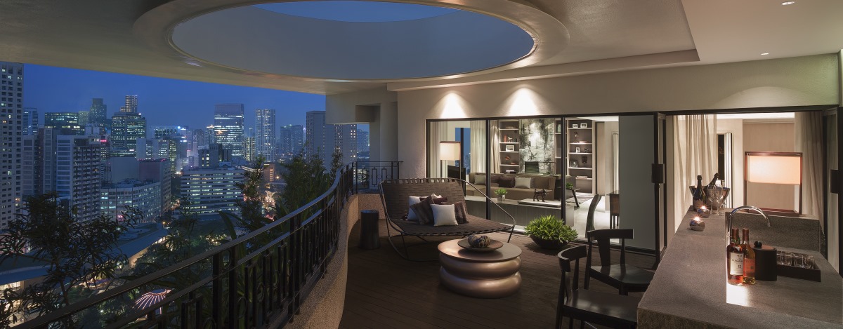 specialty suite balcony with island and stools and coffee table and couch with cushions in a Makati Luxury hotel 